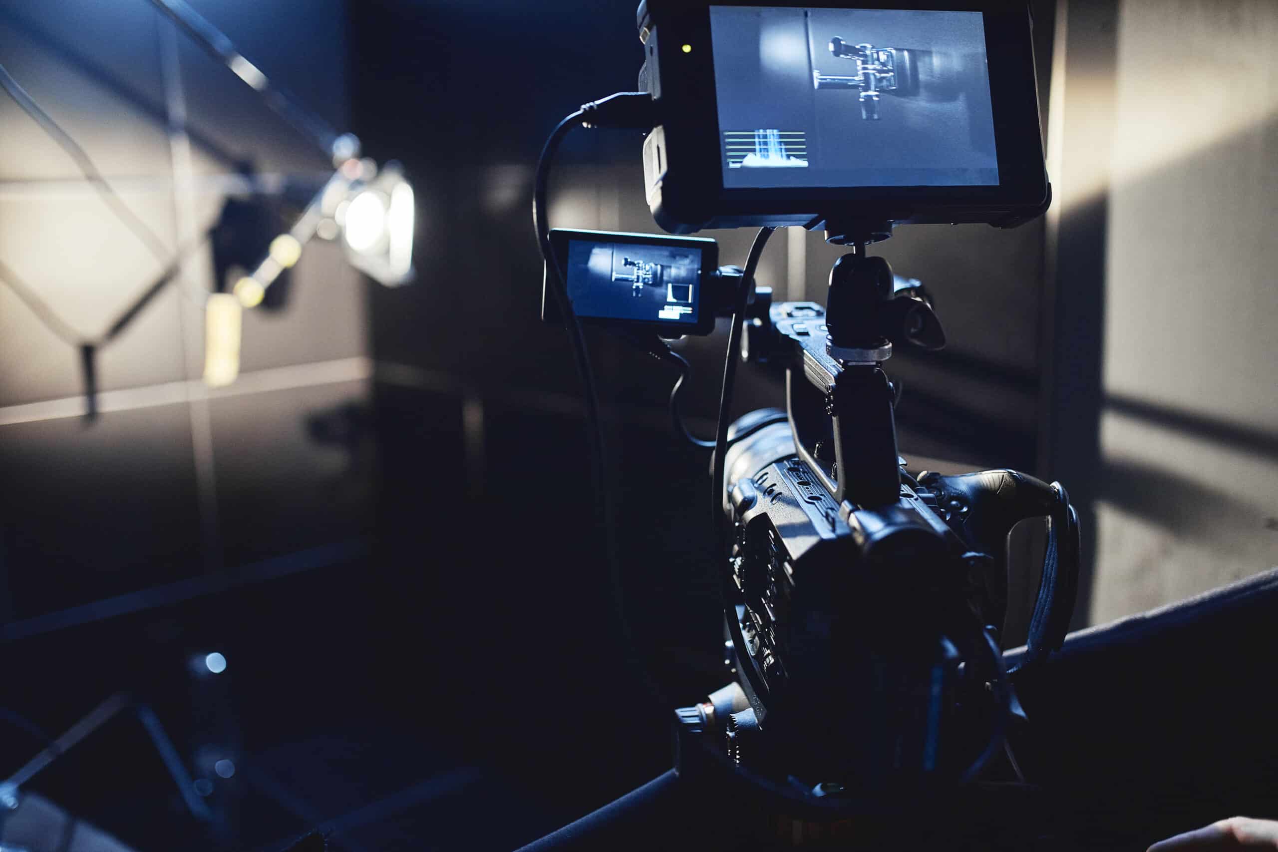 Video production backstage Behind the scenes of creating video content a professional team of cameramen with a director filming commercial ads Video content creation video creation industry Low key selective focus film graine - Best Video Production Company In Washington DC