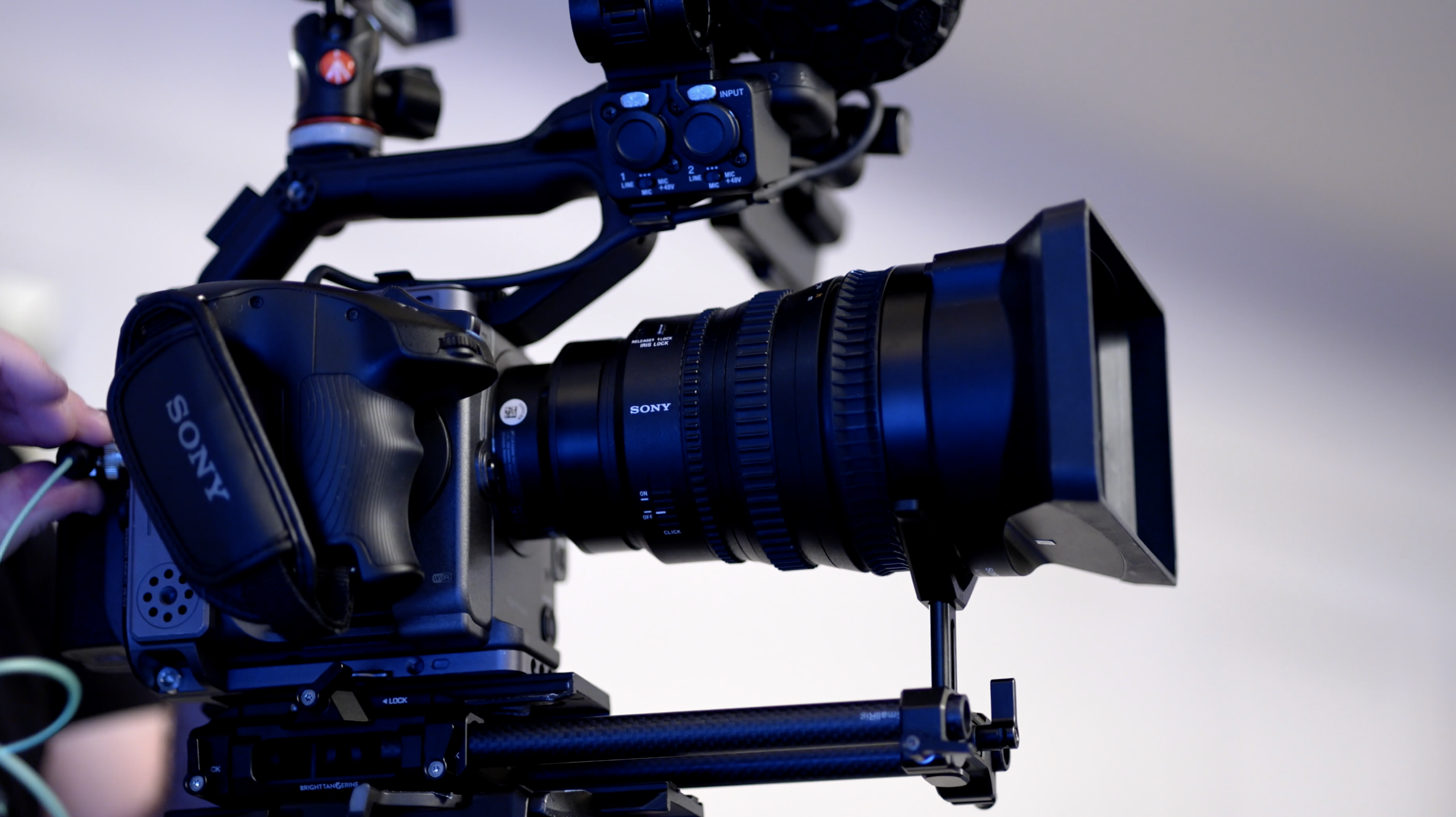Screenshot 2026-10-23 at 64325 PM - Foundation Digital Media® Close-up of a Sony professional video camera on a support rig with a large lens and matte box